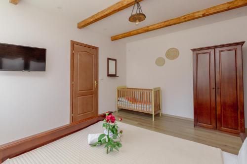 a bedroom with a crib and a room with white walls at Medo in Ulcinj