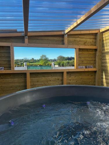 a jacuzzi tub in a wooden house at The Alpaca Farmhouse with hot tub and alpaca experience included in Dromara