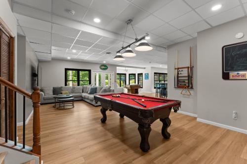 a living room with a pool table in it at Making Waves by AvantStay Sleeps 20 Pool in Westport