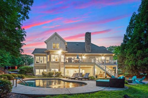 a large house with a pool and a patio at Making Waves by AvantStay Sleeps 20 Pool in Westport