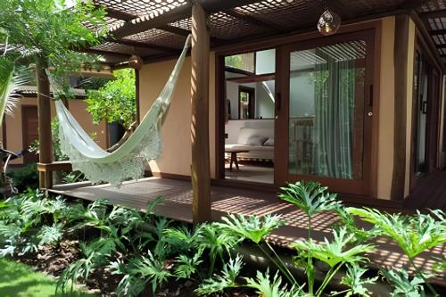 a hammock on the patio of a villa at Vida Cajuína Maraú in Marau