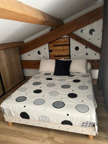 une chambre avec un lit dans un grenier dans l'établissement Maison vias village, à La Celle-sous-Gouzon