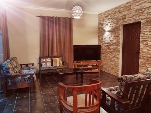 a living room filled with furniture and a flat screen tv at Villa Azalea in Grand Baie