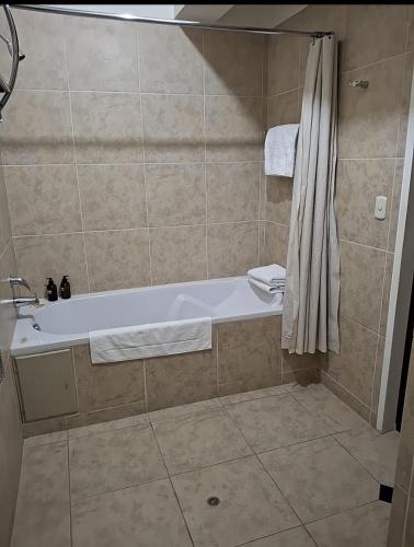 a bathroom with a tub and a shower at APU MOUNTAIN LODGE CUSCO in Cusco