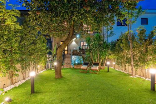 a garden with a tree and lights in front of a building at Serralves 1048 Luxury Villa in Porto