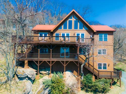 a large wooden house with a large deck at Western Wonder in Beech Mountain