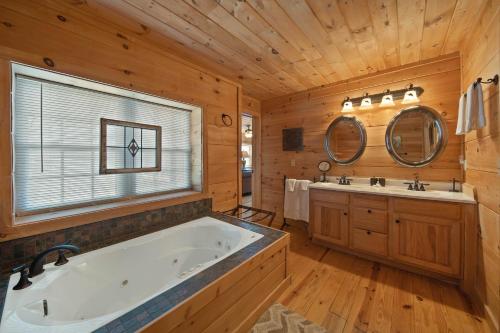 a large bathroom with a tub and two sinks at Western Wonder in Beech Mountain