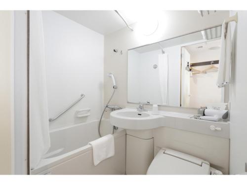 a bathroom with a sink and a toilet and a mirror at Kipp Hotel Shonan Fujisawa - Vacation STAY 05499v in Fujisawa