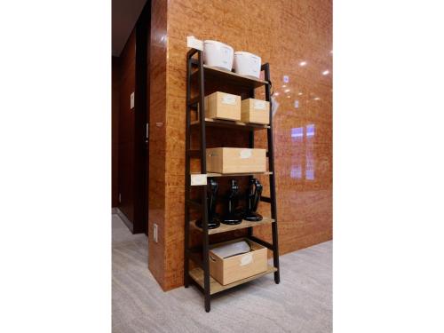 a shelf with shoes and boxes in a room at Kipp Hotel Shonan Fujisawa - Vacation STAY 05488v in Fujisawa