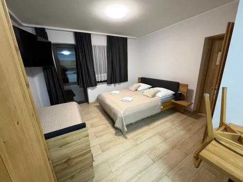 a bedroom with two beds and a mirror at Apartament Miś in Zakopane
