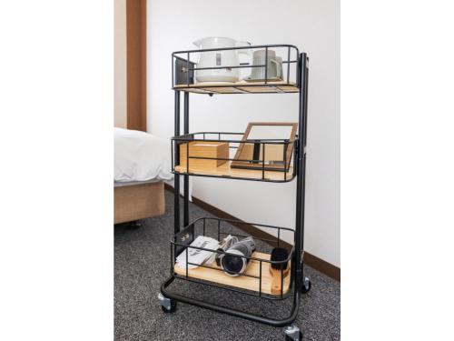 a black metal shelf with three shelves at Orient Hotel Kochi - Vacation STAY 13529v in Kochi