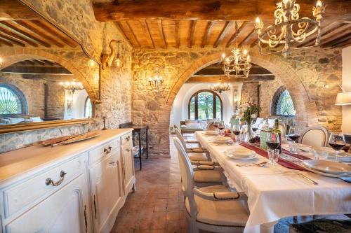 a large dining room with a long table with chairs at Villa La Lespa W-Pool Biliardo and Lake View in Casa SantʼAndrea