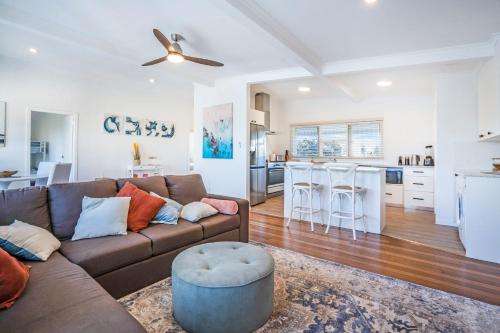 a living room with a couch and a kitchen at Yaringa -13 Seaview Street SWR in South West Rocks