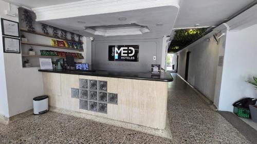 a bar in a building with a sign on the wall at Hotel Costa Caribe Barranquilla in Barranquilla