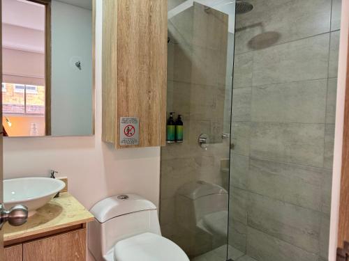 a bathroom with a shower with a toilet and a sink at Cozy Loft in 93 park in Bogotá