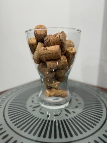 a glass vase filled with peanuts on top of a fan at A casa mia - Holiday House in Caltanissetta