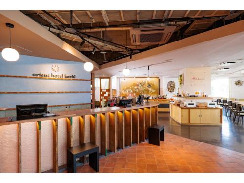 a restaurant with a bar in the middle of a room at Orient Hotel Kochi - Vacation STAY 13528v in Kochi