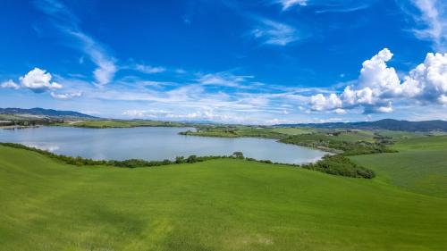 an aerial view of a lake on a green field at Villa La Lespa W-Pool Biliardo and Lake View in Casa SantʼAndrea