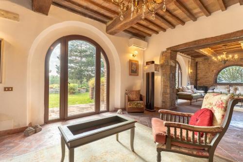 a living room with a couch and a table at Villa La Lespa W-Pool Biliardo and Lake View in Casa SantʼAndrea