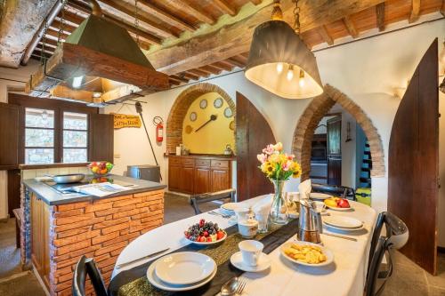 a kitchen with a table and a kitchen with arch ceilings at Villa La Lespa W-Pool Biliardo and Lake View in Casa SantʼAndrea
