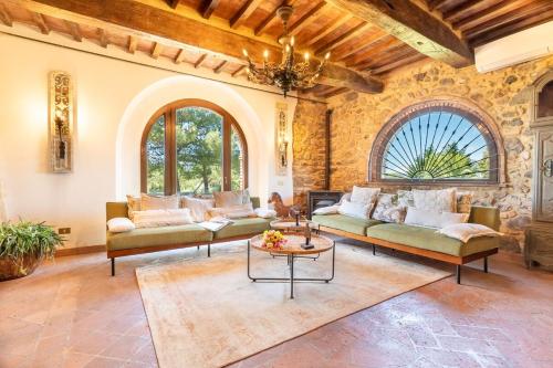 a living room with two couches and a table at Villa La Lespa W-Pool Biliardo and Lake View in Casa SantʼAndrea