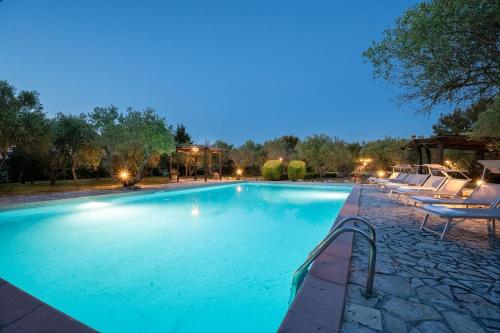a large swimming pool with lounge chairs around it at Villa La Lespa W-Pool Biliardo and Lake View in Casa SantʼAndrea
