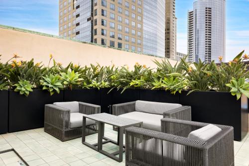a patio with a table and chairs and plants at The Guild Hotel San Diego Downtown, a Marriott Tribute Portfolio Hotel in San Diego