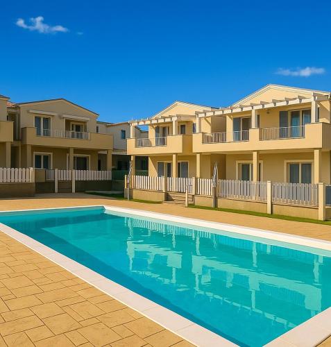 a swimming pool in front of a house at Green Villetta with a pool in Viddalba