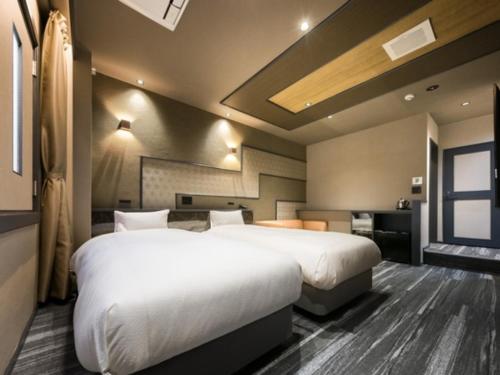 a hotel room with two beds and a window at HOTEL Noir Blanc - Vacation STAY 18104v in Shizuoka