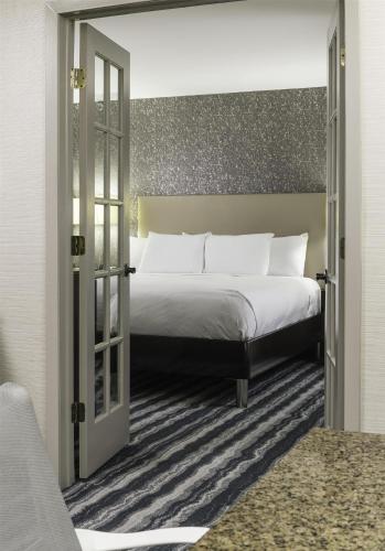 a bedroom with a large bed with white pillows at DoubleTree by Hilton Hotel Wilmington in Wilmington