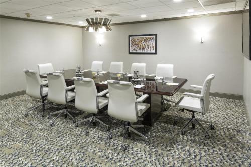 a conference room with a table and white chairs at DoubleTree by Hilton Hotel Wilmington in Wilmington