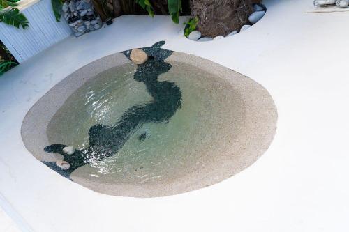 a person is standing in a pool of water at Villa Zagara Garden Spectacular Sea View in Taormina in Taormina