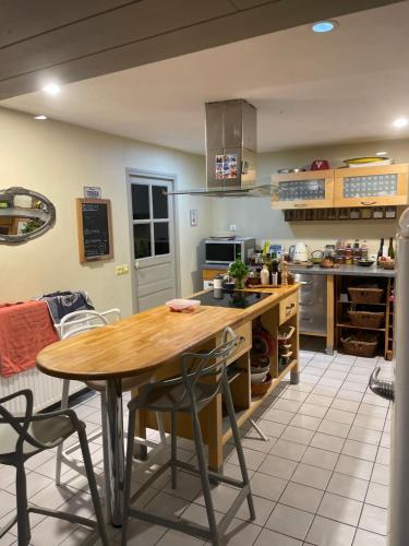 une cuisine avec une table et des chaises en bois dans l'établissement country house with pool, à La Chapelle-Blanche