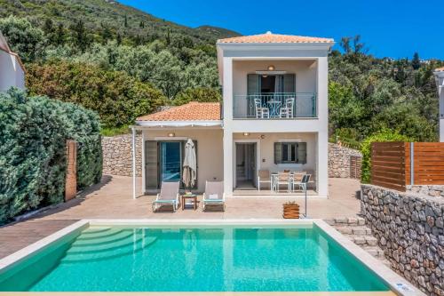 a villa with a swimming pool and a house at Villa Ira Lefkas in Póndi