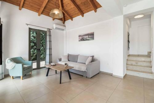 a living room with a couch and a table at Villa Ira Lefkas in Póndi