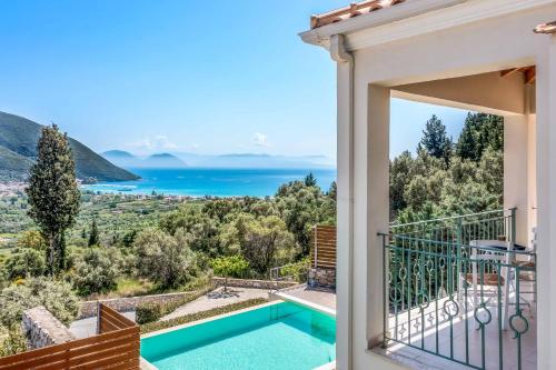 a view from the balcony of a house with a swimming pool at Villa Ira Lefkas in Póndi