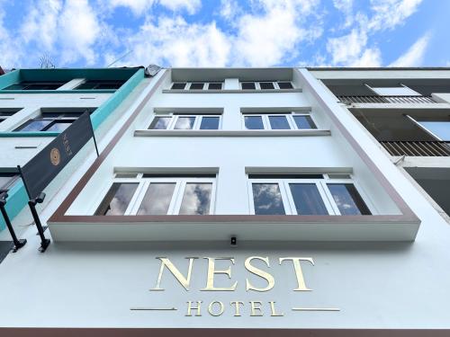 a white building with the words nest hotel at Nest Hotel Singapore in Singapore