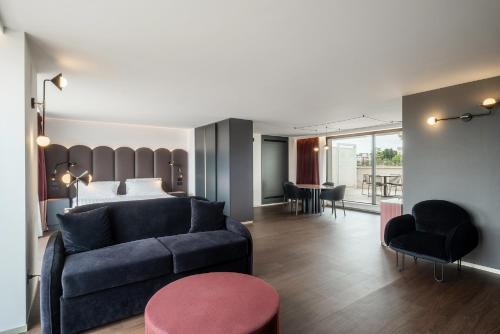 a bedroom and a living room with a couch and a bed at Eurostars Matera La Suite in Matera