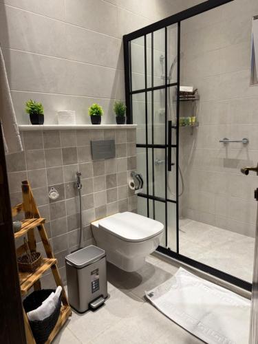 a bathroom with a shower and a toilet in it at Oak Farm مزرعة البلوط in Ajloun