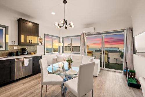 a kitchen and dining room with a table and chairs at Luxury Beachside Gem Walk to Beach Ocean Views in Manhattan Beach
