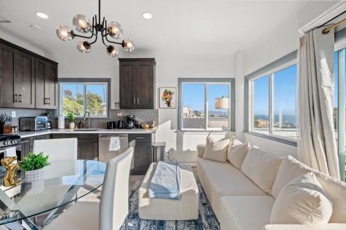a kitchen and living room with a couch and a table at Luxury Beachside Gem Walk to Beach Ocean Views in Manhattan Beach