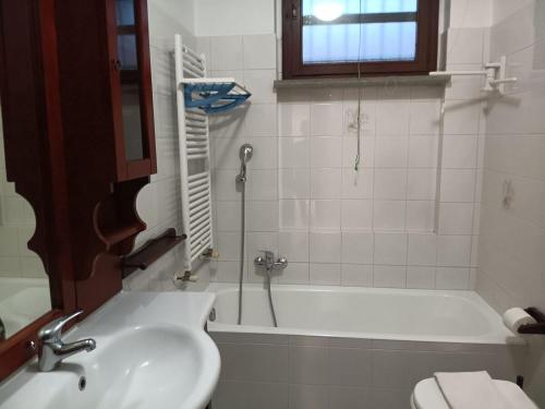 a bathroom with a sink and a tub and a toilet at Casa Girasole in Bellinzago Lombardo