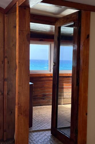 a mirror in a room with a view of the ocean at The Sea Cliff Hotel Resort & Spa in Port Antonio