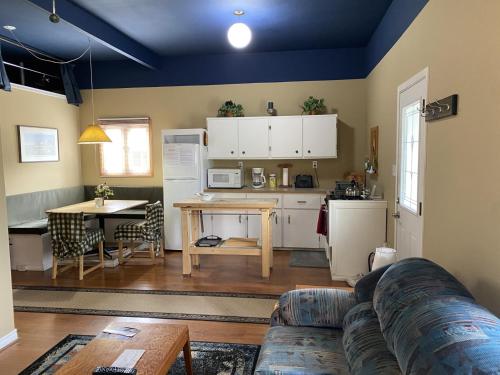 a living room with a couch and a kitchen at Witt's End Ranch Private Get Away in Princeton