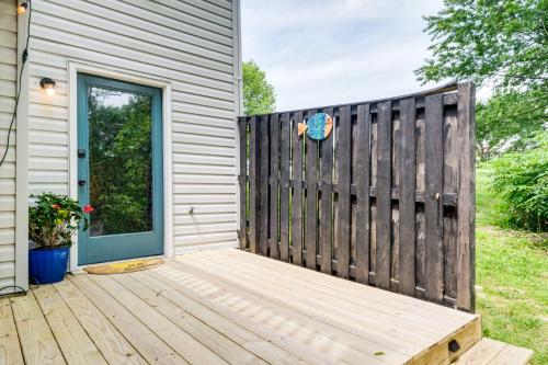 a wooden deck next to a fence with a door at 1 Mi to Boardwalk Convenient North Beach Apt! in North Beach