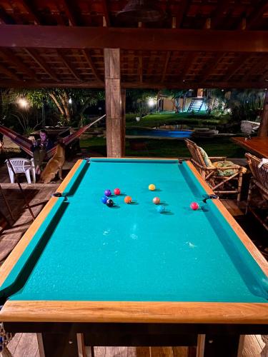 a pool table with balls on top of it at Chácara Namorada do Sol - Pousada e Camping in Guaxupé