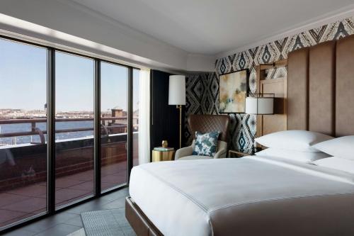 a bedroom with a large bed and a large window at Boston Marriott Long Wharf in Boston