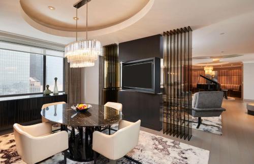 a dining room with a table and chairs and a television at The Lofton Hotel Minneapolis, Tapestry Collection by Hilton in Minneapolis