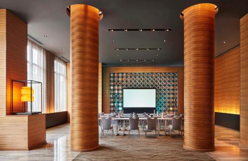 a dining room with tables and chairs and columns at The Lofton Hotel Minneapolis, Tapestry Collection by Hilton in Minneapolis