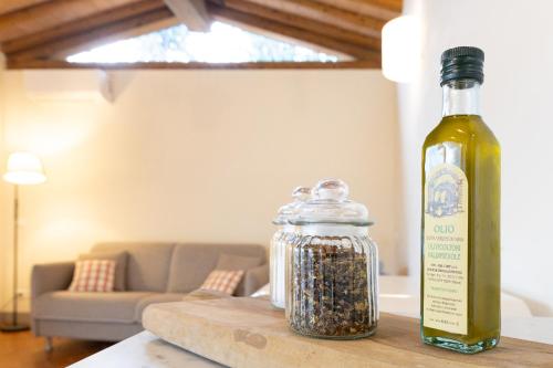a bottle of wine and a jar of spices on a table at Agriturismo Fonteregia in Montecatini Terme